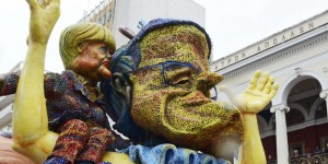 A carnival float depicting Greece's former conservative PM Samaras and German Chancelor Merkel sitting on his shoulder, is seen during a parade marking carnival celebrations in the southwestern town of Patras