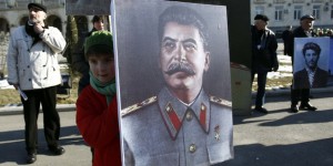 People carry portraits of late Soviet dictator Josef Stalin as they attend a gathering marking the 130th anniversary of his birthday in Stalin's hometown town of Gori